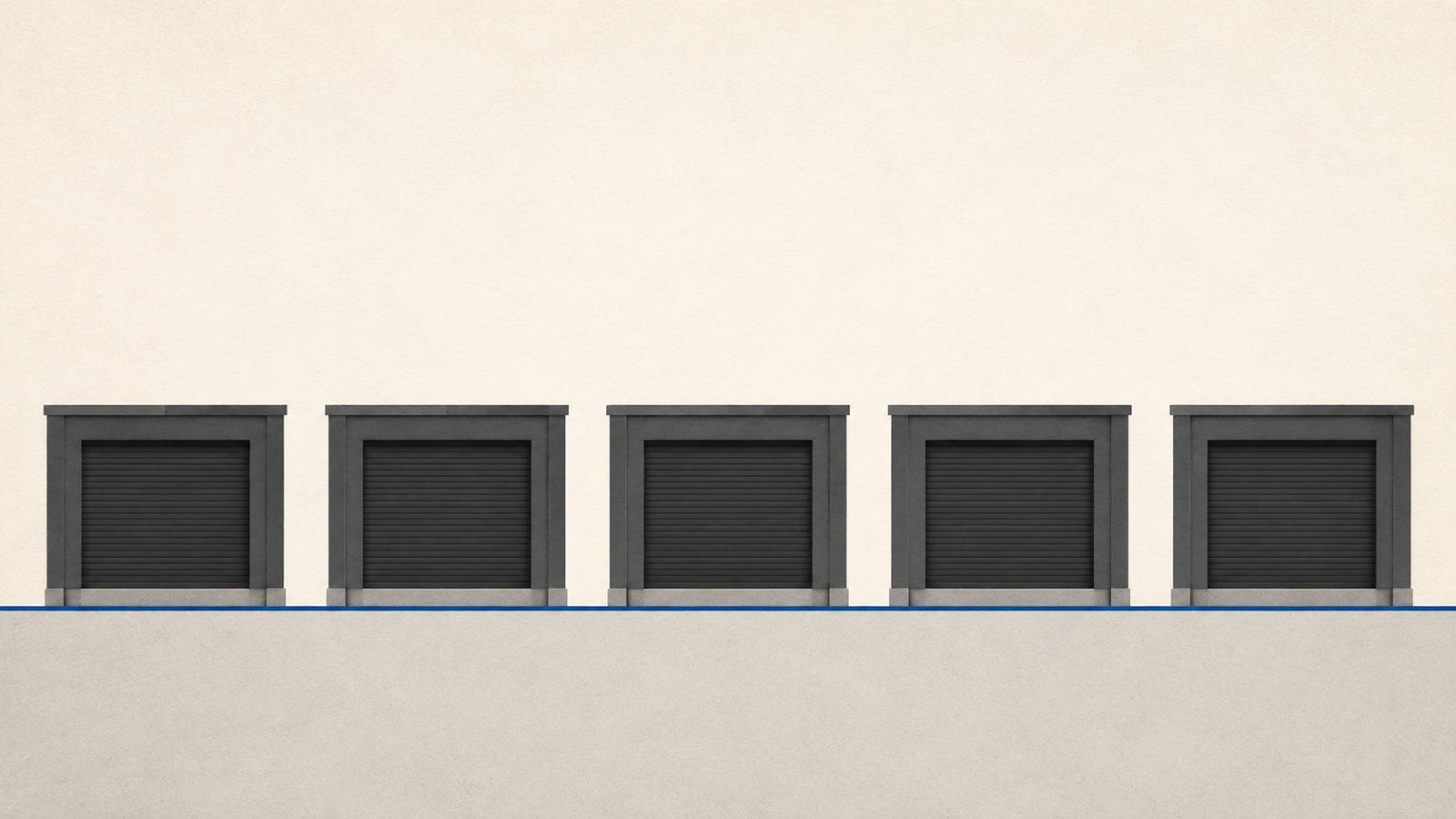 A row of identical self-storage roll-up doors along a plain facade